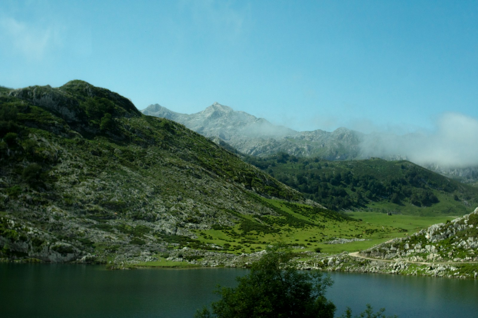 a view of a mountain range with a lake in the foreground