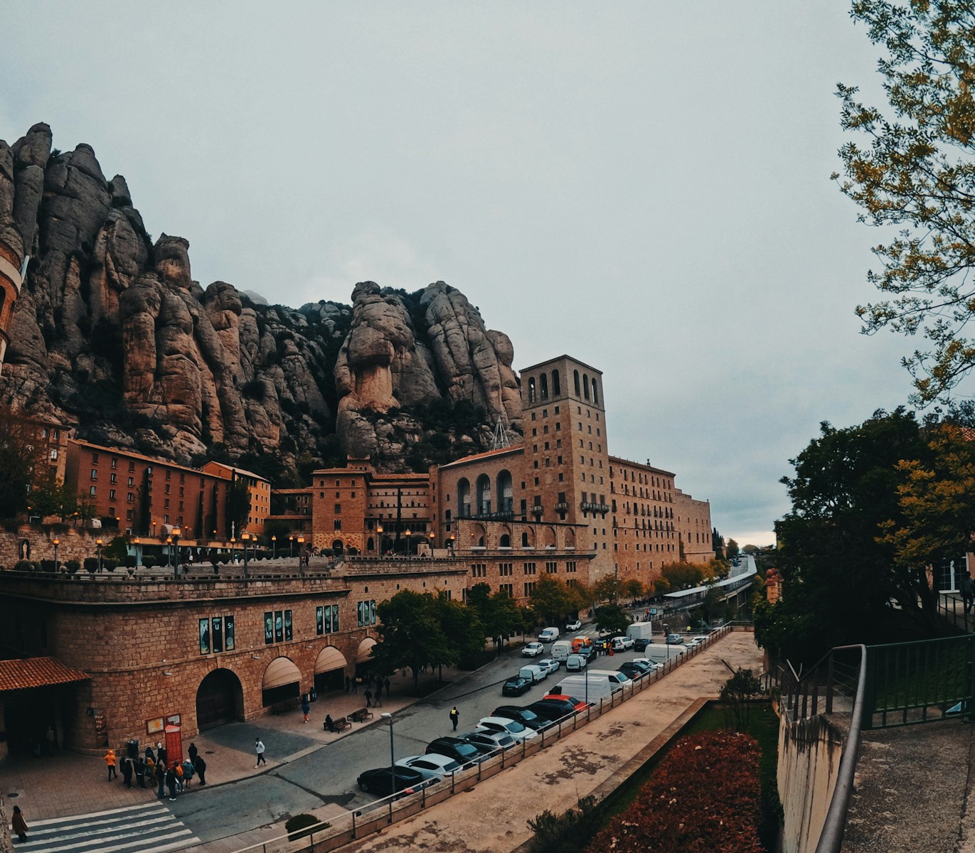 cars parked on the side of a road in front of a mountain